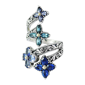 SS/18K BLUE MULTI GEMSTONE FLOWER BYPASS RING